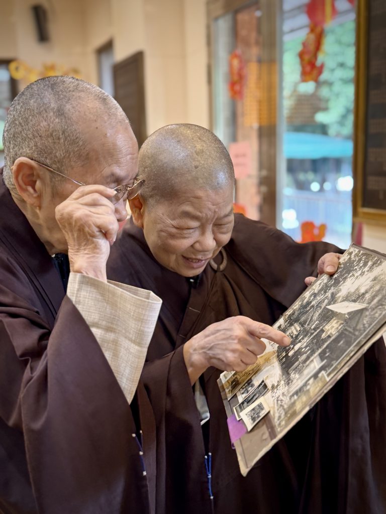 秉鴻法師與宏量法師捧著兒時的舊照，憶述她們的往事