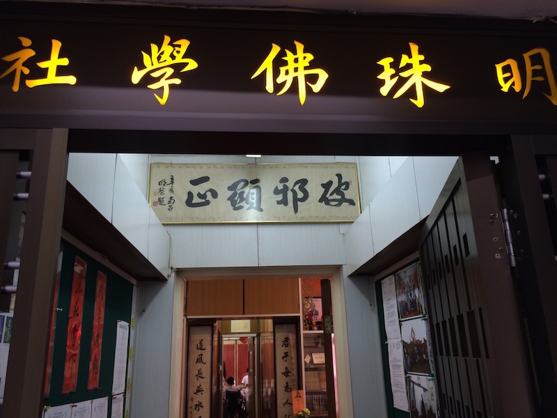 步入明珠佛學社,迎面即見門額橫匾「破邪顯正」,筆力蒼勁,正是創社人明慧法師的手澤。